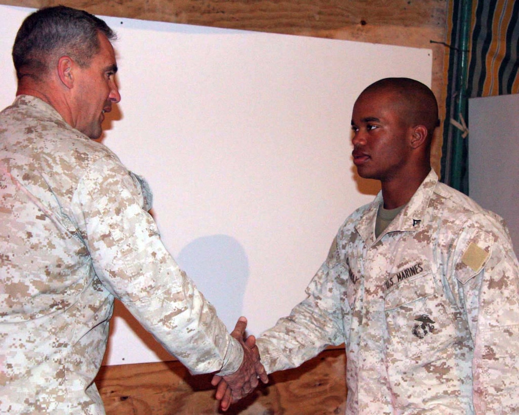 Lance Corporal Daniel Callaway a logistics embarkation specialist and a native of Fayetteville N.C., receives an award for being named Marine of the Quarter from Col. Ron Johnson on July 12. Callaway is on his first deployment with the 24th Marine Expeditionary Unit and is enjoying the experience in a new environment. "I'm glad to be apart of a unit that is capable of quickly and effectively responding to America's needs," said Callaway.  (U.S. Marine Corps Photo by Lance Cpl Joshua Lujan)
