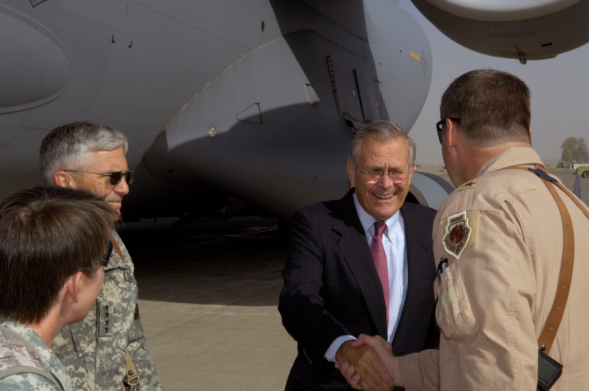 Secretary of Defense Donald H. Rumsfeld shakes hands with Brig. Gen. Robin Rand as he arrives at Balad Air Base, Iraq, on July 12. Secretary Rumsfeld is visiting Iraq to talk with servicemembers. General Rand is commander of the 332nd Air Expeditionary Wing. (U.S. Air Force photo/Airman 1st Class Andrew Oquendo)