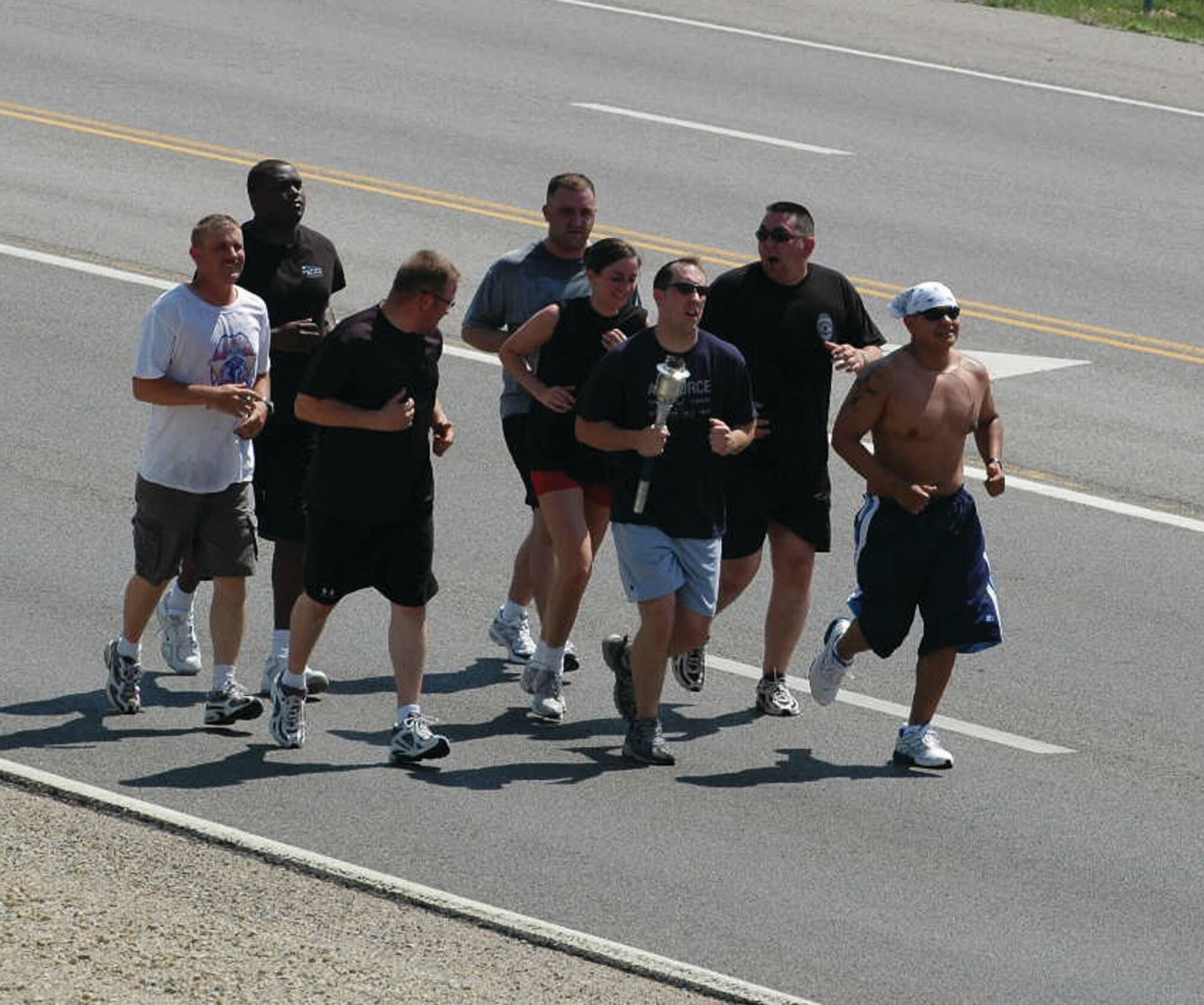 Members of the 931st SF, braving temperatures in the upper nineties, ran the Special Olympic torch from Derby, Kan. through the base.
