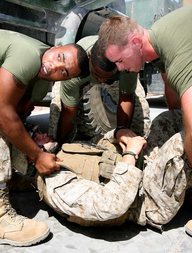 Marines with 3rd platoon, Hotel Battery 3/14, practice the different ways to safely remove an injured Marine from a disabled 7-ton truck.
