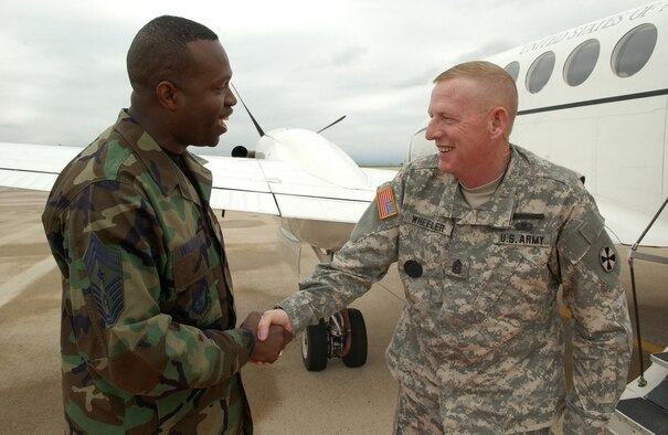 KUNSAN AIR BASE, Republic of Korea -- Sgt. Maj. Barry Wheeler, United States Forces Korea command sergeant major, was greated upon his arrival by the Wolf Pack?s top enlisted member, Command Chief Master Sgt. Reggie ?Wolf Chief? Williams. (Air Force photo by Staff Sgt. Josef Cole)