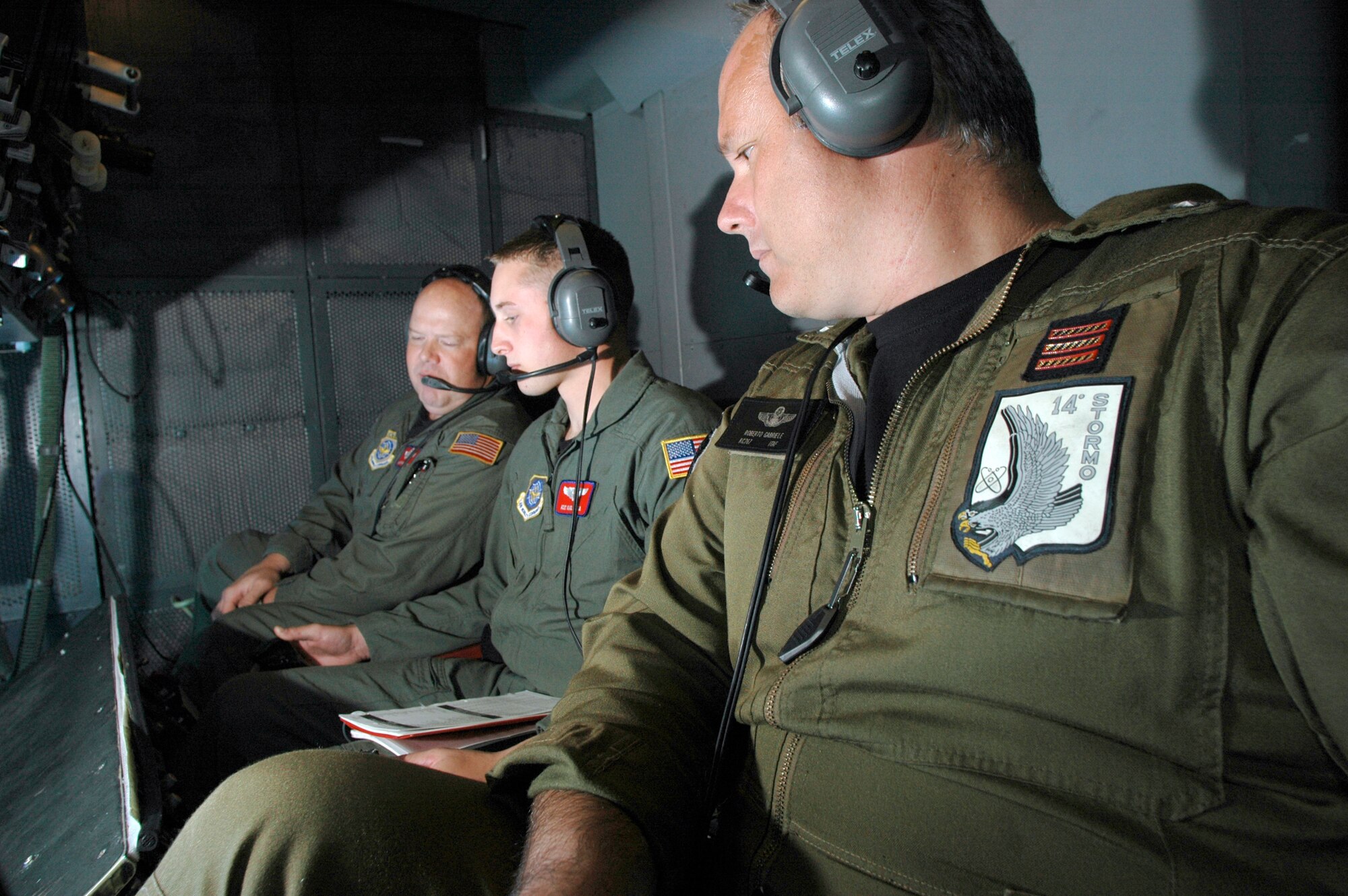 Master Sgt. Keith Van Camp, KC-10 formal training unit instructor overseas Airman 1st Class Karl Wooda, KC-10 boom operator student, as he refuels an aircraft. Italian warrant officer and student, Roberto Gabriele looks on. Warrant Officer Gabrielle is one of four Italian Warrant officers who completed the final phase of the Air Force KC-10 boom operator’s course here today. (Photo by Kenn Mann)