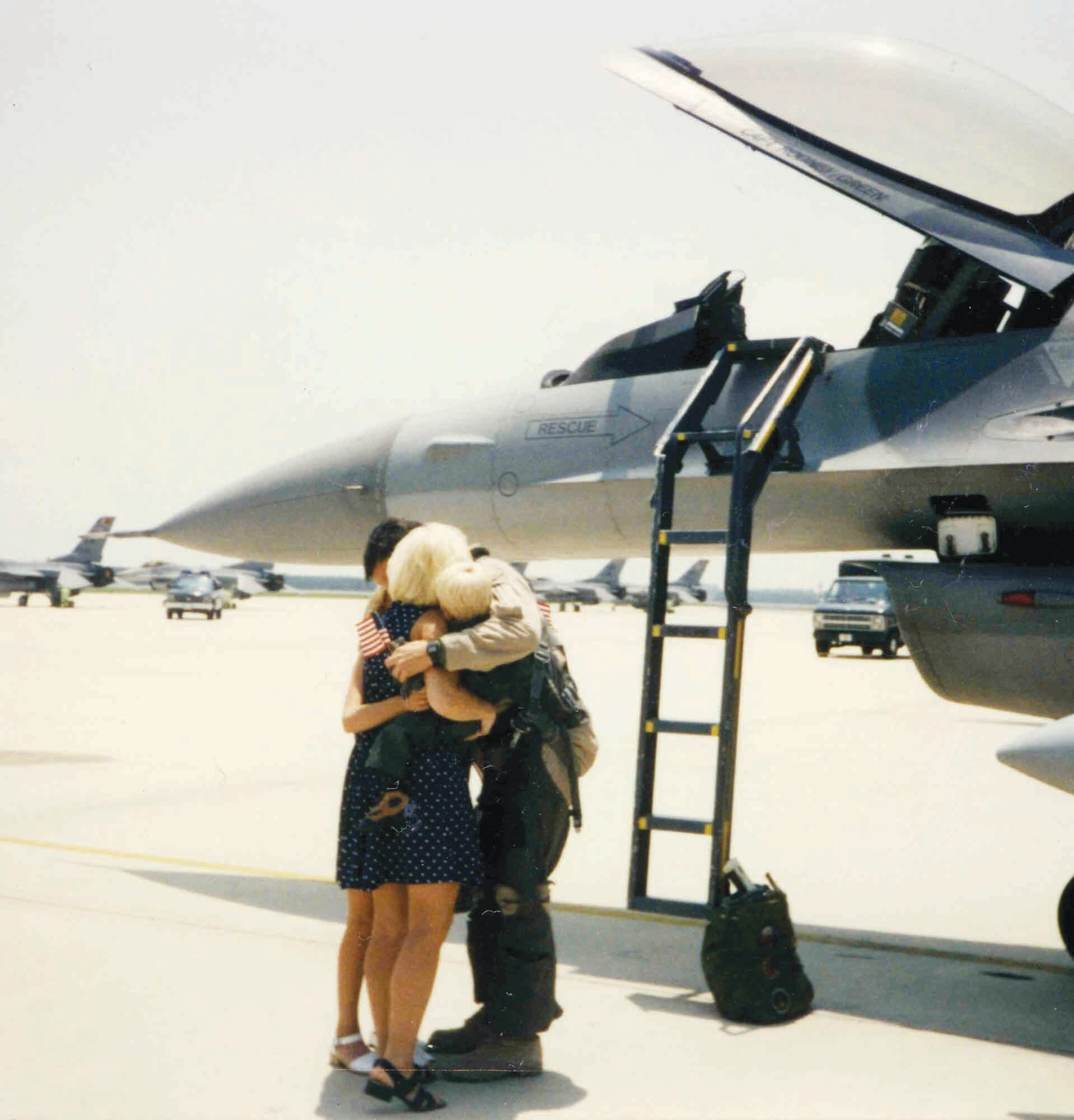 Lt. Col. Don Butler, 20th Fighter Wing plans and programs chief, is greeted by his family on the flightline 10 years ago after returning to Shaw from Saudi Arabia.  Col. Butler  was at Khobar Towers during the bombing.  (Courtesy photo)
