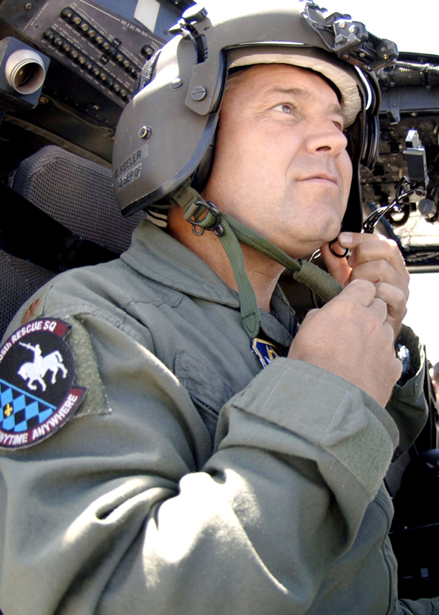 Maj. John Keeler gets his gear ready as he prepares to take off in an HH-60 Pave Hawk at Davis-Monthan Air Force Base, Ariz., for a test flight on July 10. Major Keeler participated in a real-world rescue of an individual from a cargo ship off the coast of California on July 1. He is assigned to the Air Force Reserve Command's 943rd Rescue Squadron. (U.S Air Force photo/Senior Airman Christina D. Ponte)