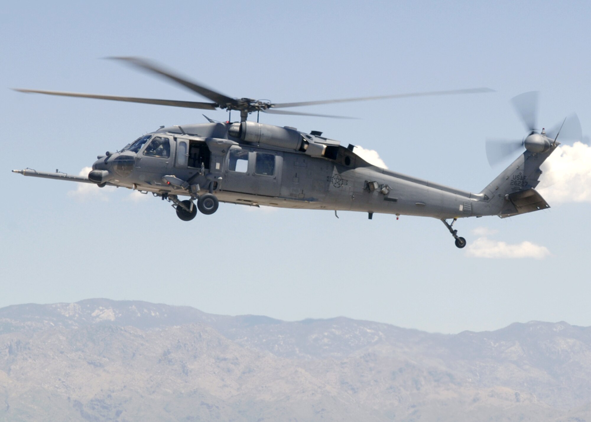 Maj. John Keeler hovers over the flightline in an HH-60 Pave Hawk at Davis-Monthan Air Force Base, Ariz., as he performs a test flight on July 10. Major Keeler participated in a real-world rescue of an individual from a cargo ship off the coast of California on July 1. He is assigned to the Air Force Reserve Command's 943rd Rescue Squadron.(U.S Air Force photo/Senior Airman Christina D. Ponte)