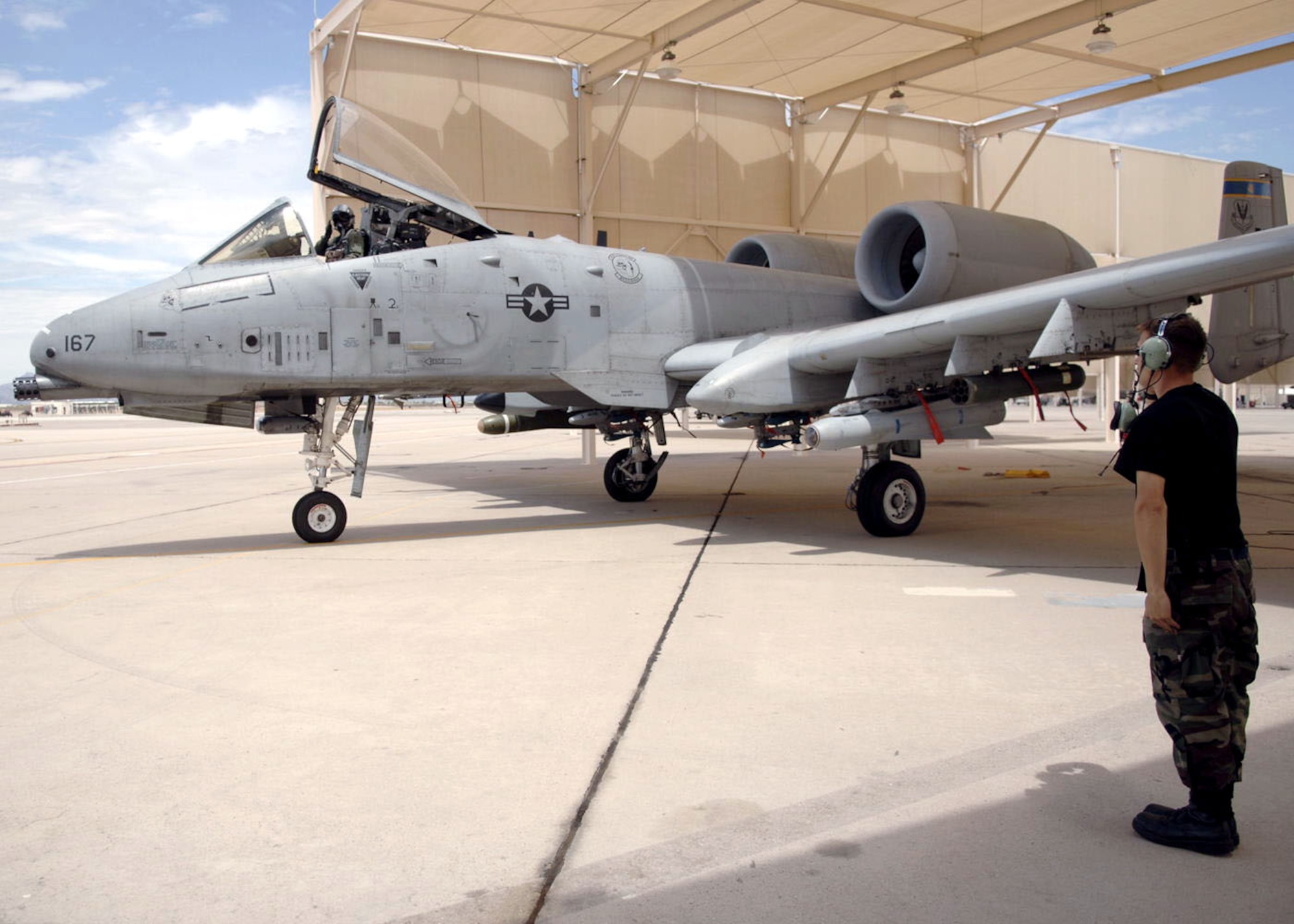 Airman 1st Class Brett Davis marshals Lt. Col. Francis McDonough as he prepares to take off in his A-10 Thunderbolt II at Davis-Monthan Air Force Base, Ariz., on July 7. Colonel McDonough is assigned to the 355th Wing. He was recently deployed to Bagram Air Base, Afghanistan, in support of Operation Enduring Freedom. Airman Davis is a crew chief with the 354th Aircraft Maintenance Unit. (U.S Air Force photo/Senior Airman Christina D. Ponte)