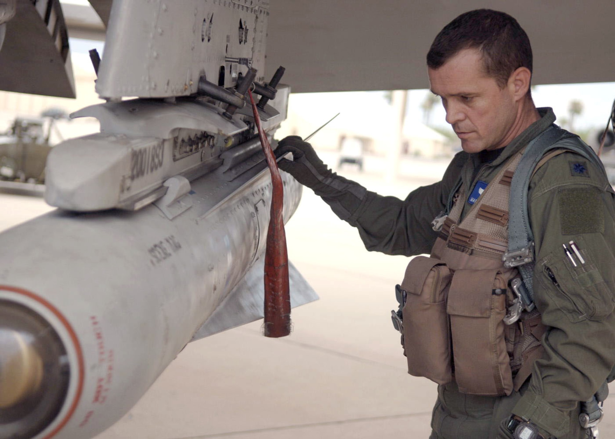 Lt. Col. Francis McDonough performs pre-flight inspections on an A-10 Thunderbolt II as he prepares for a sortie at Davis-Monthan Air Force Base, Ariz., on July 7. Colonel McDonough is assigned to the 355th Wing and was recently deployed to Bagram Air Base, Afghanistan, in support of Operation Enduring Freedom. (U.S Air Force photo/Senior Airman Christina D. Ponte)