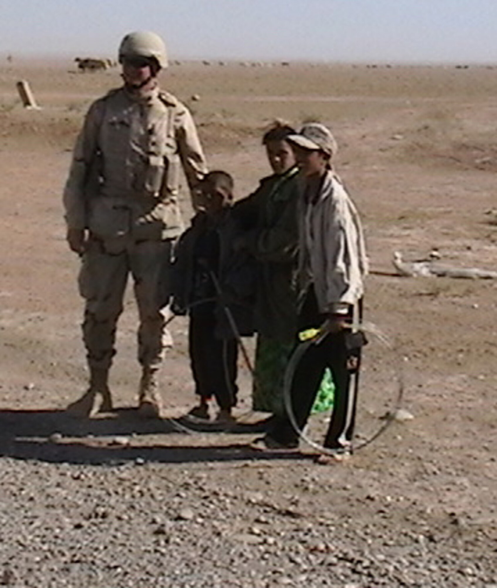 While helping to build roads in Iraq, Master Sgt. Harvey Rouse, Jr., talked to some of the Iraqi children. Sergeant Rouse is a pavement and construction equipment technician with the 916th Civil Engineer Squadron.