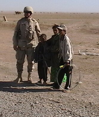 While helping to build roads in Iraq, Master Sgt. Harvey Rouse, Jr., talked to some of the Iraqi children. Sergeant Rouse is a pavement and construction equipment technician with the 916th Civil Engineer Squadron.