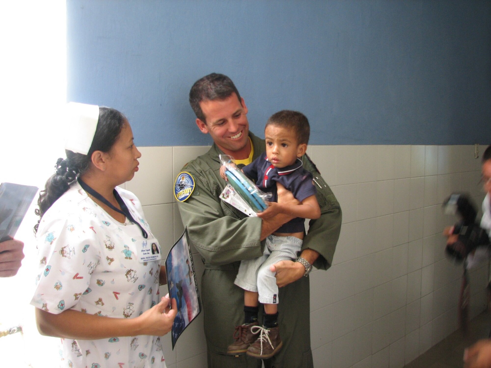 Maj. Jason Koltes, Viper East commander and demonstration pilot, visits a child in a hospital in Medellin, Colombia.  (U.S. Air Force photo/1st Lt. Christina Mundy)
