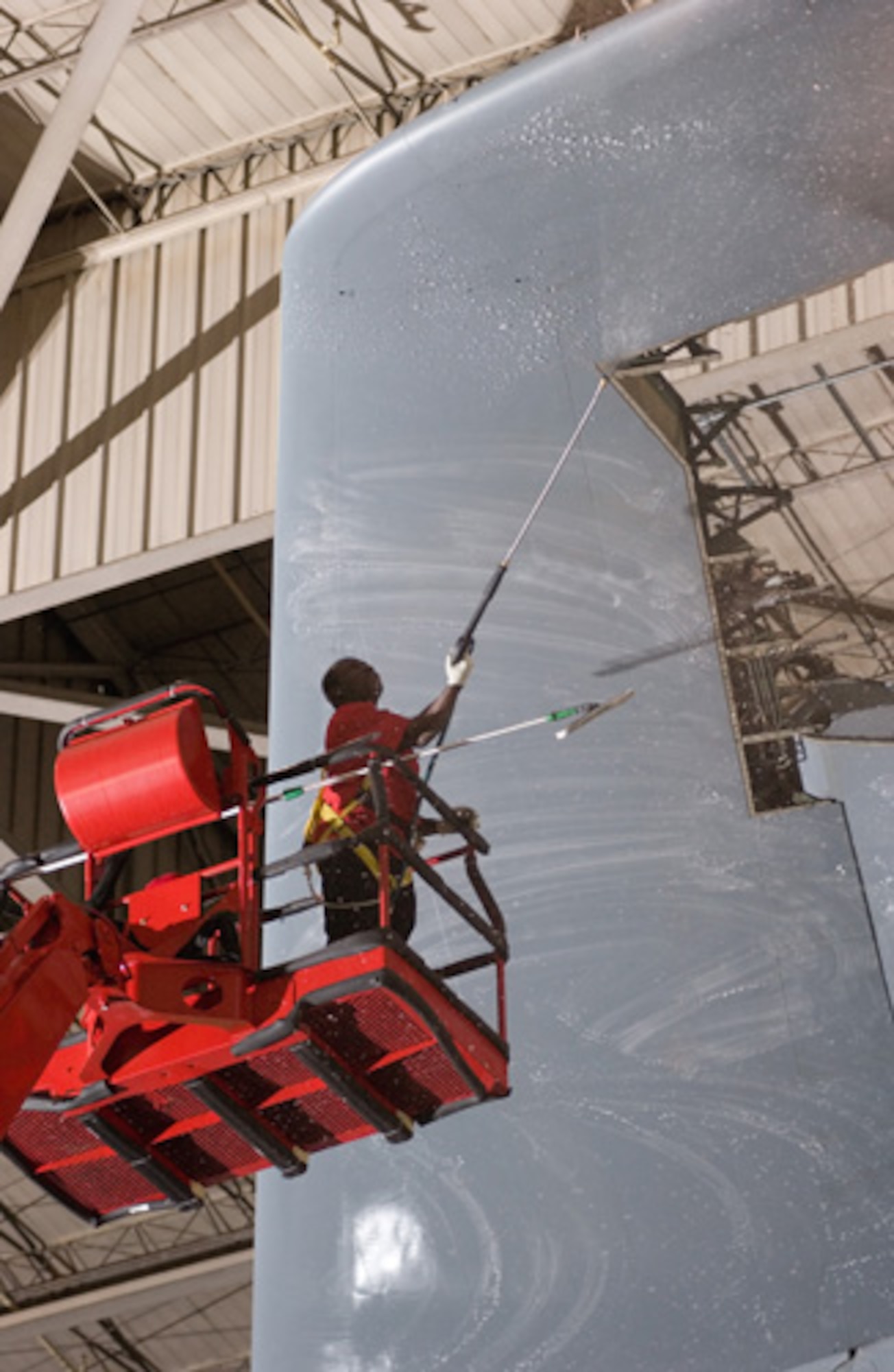 Moore Kpana, Starlight Corporation aircraft servicer, washes tail number 70033's aft fuselage at Dover Air Force Base, Del. The military contractor is responsible for cleaning Dover's more than 25 C-5 Model B Galaxy aircraft. The wash process helps extend the life cycle of the plane. 