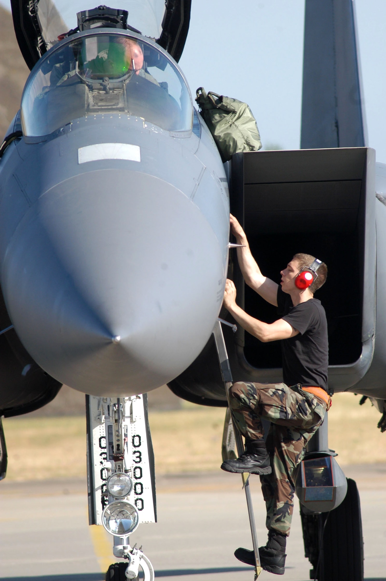Airman 1st Class Nathan Schott climbs from an F-15E Strike Eagle before the first launch of the modified aircraft on an operational training mission carrying the newest small-diameter bomb, the guided bomb unit-39. Airman Schott is an assistant dedicated crew chief with the 494th Aircraft Maintenance Unit at Royal Air Force Lakenheath, England. (U.S. Air Force photo/Airman 1st Class Michael Hess)