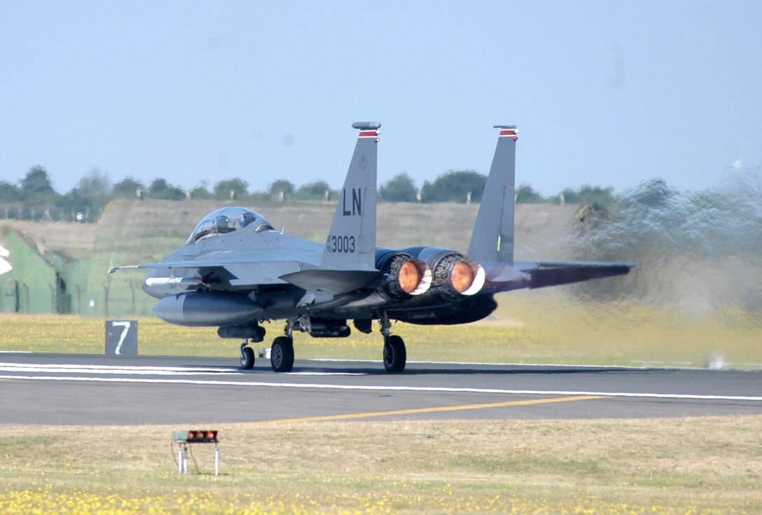 A modified F-15E Strike Eagle, assigned to the 494th Fighter Squadron, launched on an operational training mission with the bomb release unit-61 attached to the center pylon at Royal Air Force Lakenheath, England, Monday. The aircraft was one of four to participate in the first training mission with the new technology. The BRU-61 carries the newest small-diameter bomb, the guided bomb unit-39, into battle when the unit deploys in September. (U.S. Air Force photo/Airman 1st Class Michael Hess)