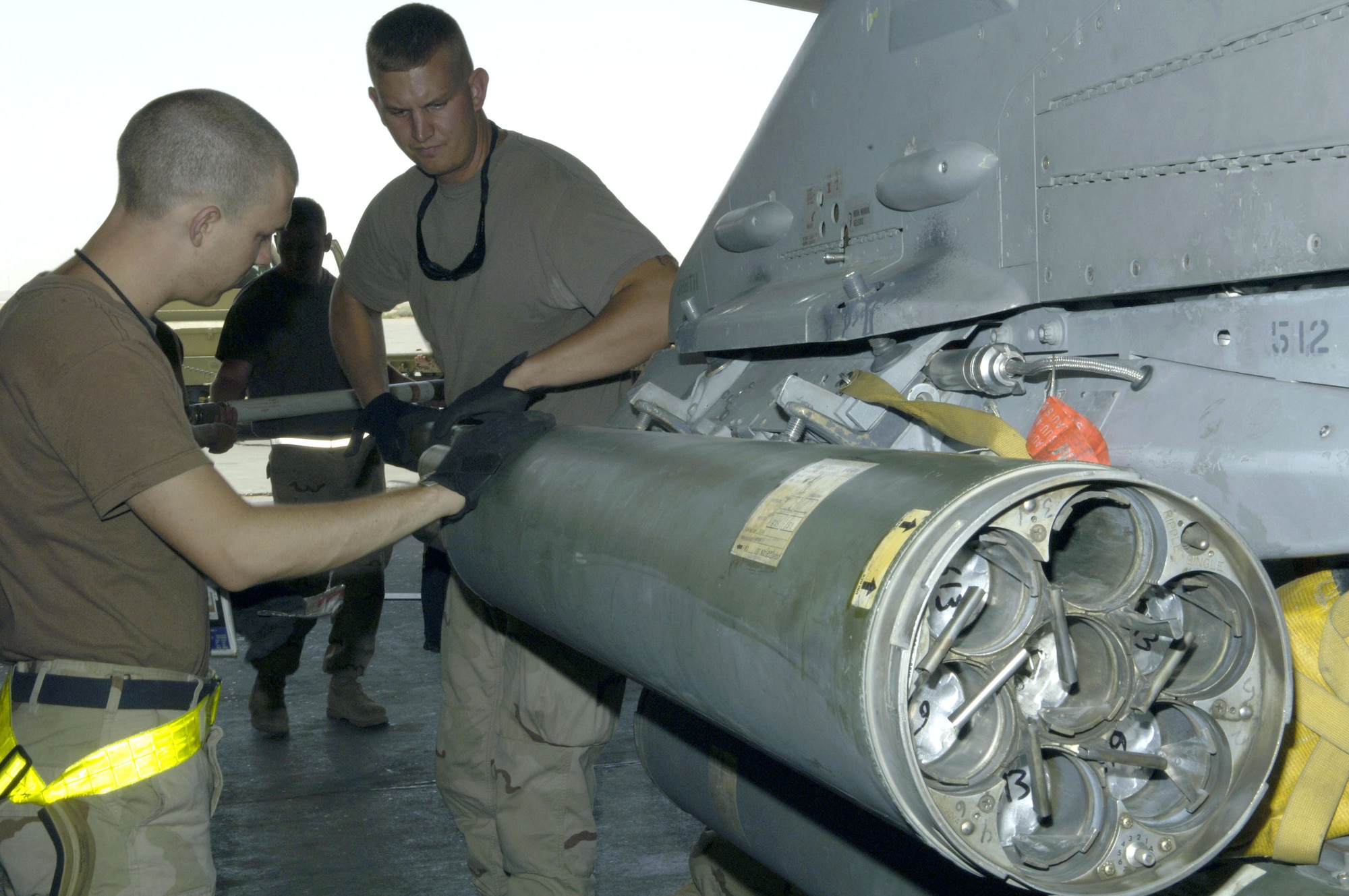 Senior Airman Nathan Stolle (left) helps Staff Sgt. Charles Evelo arm an F-16 Fighting Falcon with illumination rockets at Balad Air Base, Iraq, on July 11. Both Airmen are assigned to the 421st Expeditionary Aircraft Maintenance Squadron. (U.S. Air Force photo/Airman 1st Class Andrew Oquendo)
