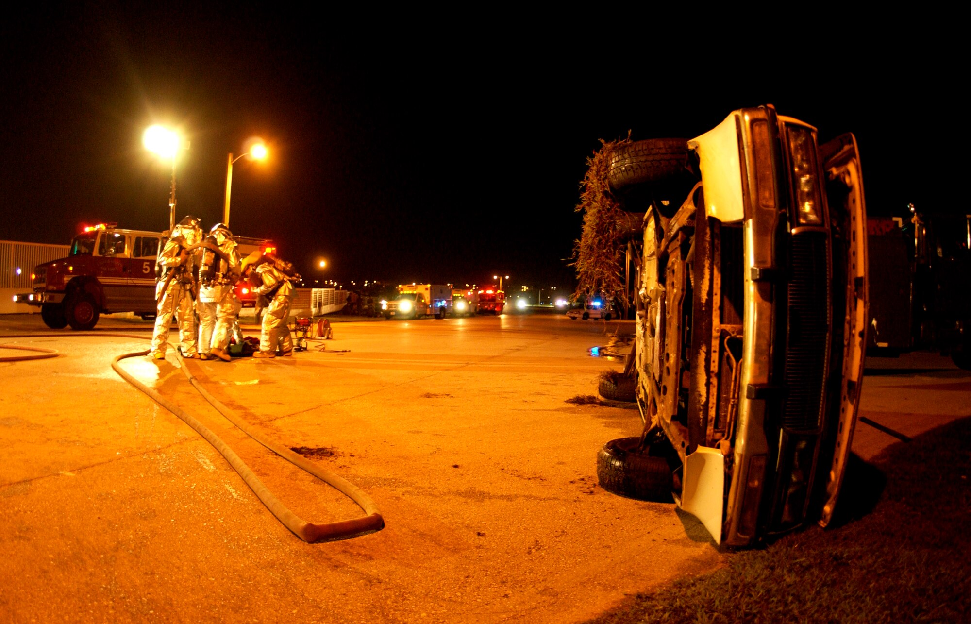 Firefighters from the 36th Civil Engineer Squadron respond to a simulated vehicle accident at Andersen Air Force Base, Guam, during the Beverly Palm 06-07 exercise on July 10. The exercise is held several times a year to sharpen the mobility and wartime capabilities of Airmen. (U.S. Air Force photo/Airman 1st Class Miranda Moorer)
