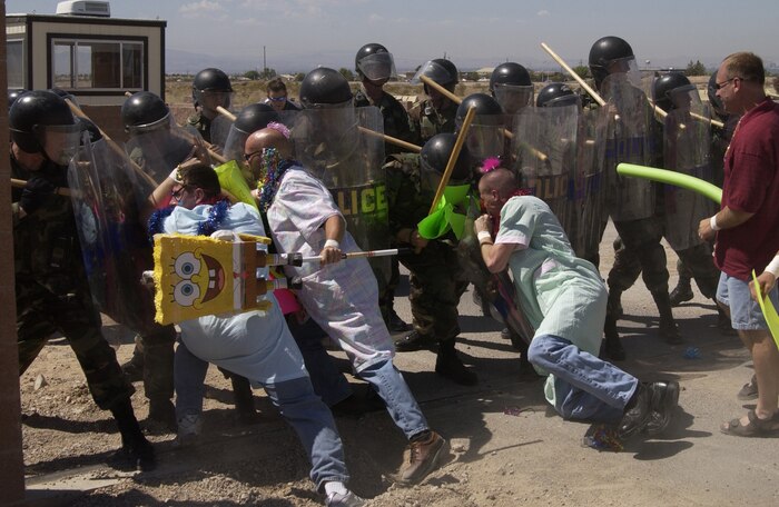 Nellis Airmen stage a mock protest as part of an Office of Special Investigations exercise Tuesday. The quarterly exercise allows members of the 99th Security Forces Squadron to develop and practice crowd-control tactics for real-world situations. (U.S. Air Force photo/Airman 1st Class Jason Huddleston)
