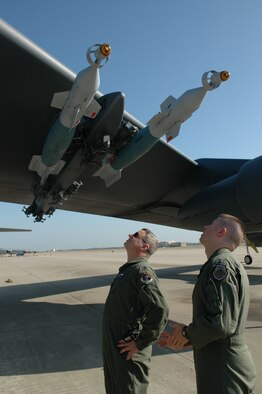 Lt. Col. Al Teauseau, 93rd Bomb Squadron commander, and a fellow captain perform pre-flight checks on the B-52 prior to departure. The LITENING AT targeting pod attached to the other wing, will give commanders in theater the capability to have a precision weapon platform airborne for long periods of time. (U.S. Air Force photo/1st Lt. Torri White)