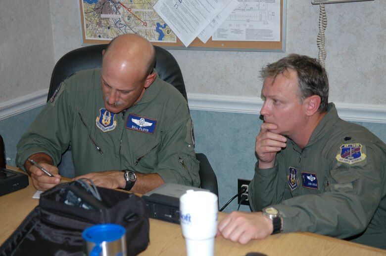 Lt. Col. William Floyd, 93rd Bomb Squadron Weapons and Tactics Flight commander, reviews the LITENING AT targeting pod tape with Lt. Col. Joe Jones, 93 BS B-52 instructor radar navigator. The LITENING AT uses high definition electro-optical sensors and airborne lasers to aid the aircrew with target detection, identification and weapons guidance precision. (U.S. Air Force photo/1st Lt. Torri White)
