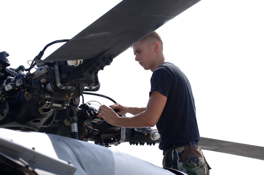 MOODY AIR FORCE BASE, Ga. -- Airman 1st Class Nicholas Rice, 347th Aircraft Maintenance Squadron here, checks transmission fluid on an HH-60G Pave Hawk. The 347th Maintenance Group is currently planning for an in-depth inspection from Feb. 26 to March 26, 2007, performed by the Logistics Standardization and Evaluation Team. (Photo by Airman 1st Class Schelli Howard)