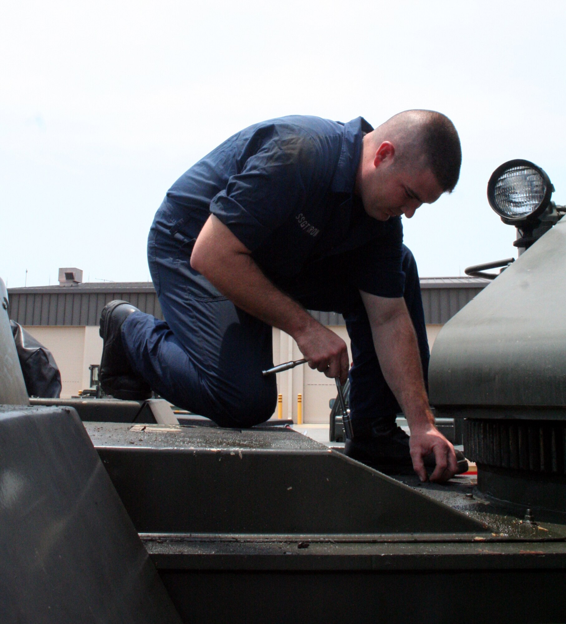 Staff Sgt. Clay Crow repairs a mission-critical crane in the 16th LRS vehicle maintenance parking lot. (U.S. Air Force Photograph by Jamie Haig)