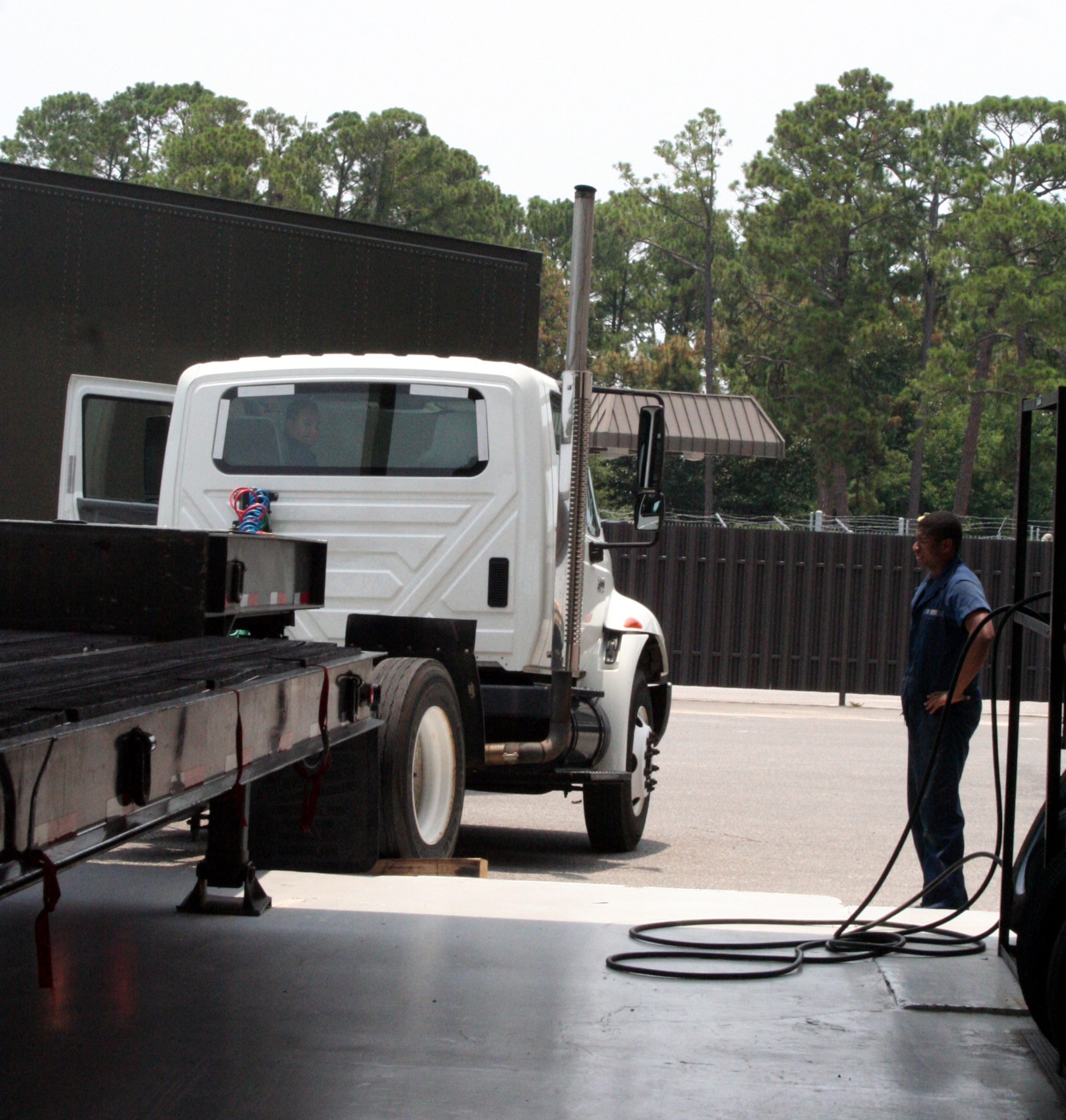 Senior Airman Joseph Burress (in truck) and Senior Airman Lewis Powell, begin troubleshooting the brakes on a tractor trailer. (U.S. Air Force Photograph by Jamie Haig)