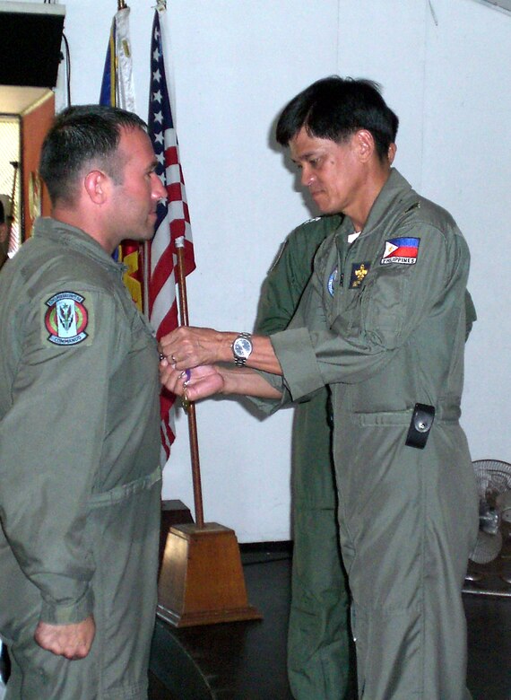 Tech. Sgt. Daniel Weimer, 6th Special Operations Squadron, receives the Philippine Civic Action Medal from Philippine Air Force Brig. Gen. Michael Mendoza, 205th Tactical Helicopter Wing commander. (U.S. Air Force Photograph by Master Sgt. Paul Chick)
