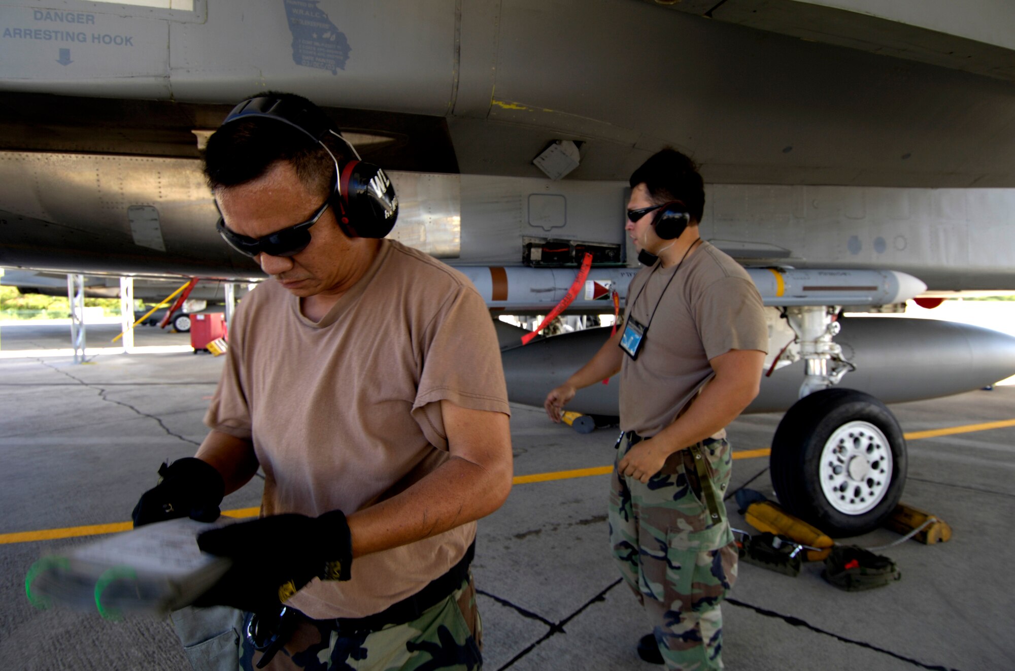 HICKAM AIR FORCE BASE, Hawaii -- Staff Sgt. Arthur Hamabata looks over his checklist after installing an AIM-7 Sparrow missile on F-15 Eagle at Hickam Air Force Base Hawaii July 16, 2006 during Rim of the Pacific Exercise 2006. The Sgt. is from the Hawaii Air National Guard 154th Aircraft Maintenance Squadron. The Eagles will be firing 14 live missiles at two decoy targets during RIMPAC. RIMPAC 2006 brings friendly forces from the Pacific theater and the United Kingdom together to engage in air and sea war games. (U.S. Air Force photo/ Tech. Sgt. Shane A. Cuomo)