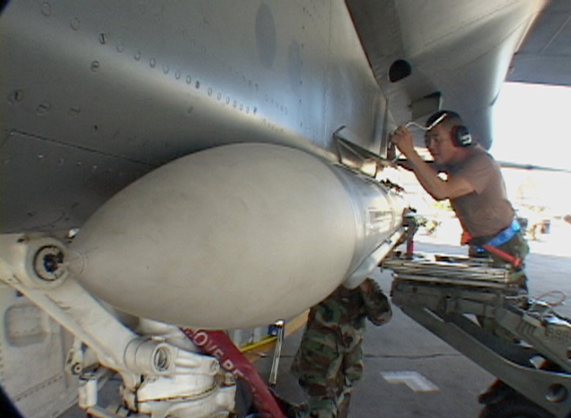 HICKAM AIR FORCE BASE, Hawaii -- Hawaii Air National Guard Airmen attach an AIM-7 missile to an F-15 at Hickam AFB, Hawaii on July 16, 2006.  (US Air Force photo by Tech. Sgt. Chris Vadnais) 