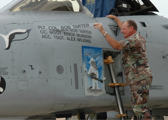 Master Sgt. Rick Munson, 717th Aircraft Maintence A-10 aircraft mechanic, removes Brig. Gen. Bob Tarter's old aircraft nameplate to reveal the newly painted one Saturday, July 8, at Barksdale AFB, La., following General Tarter's promotion July 1. (U.S. Air Force photo/Tech. Sgt. Sherri Savant)