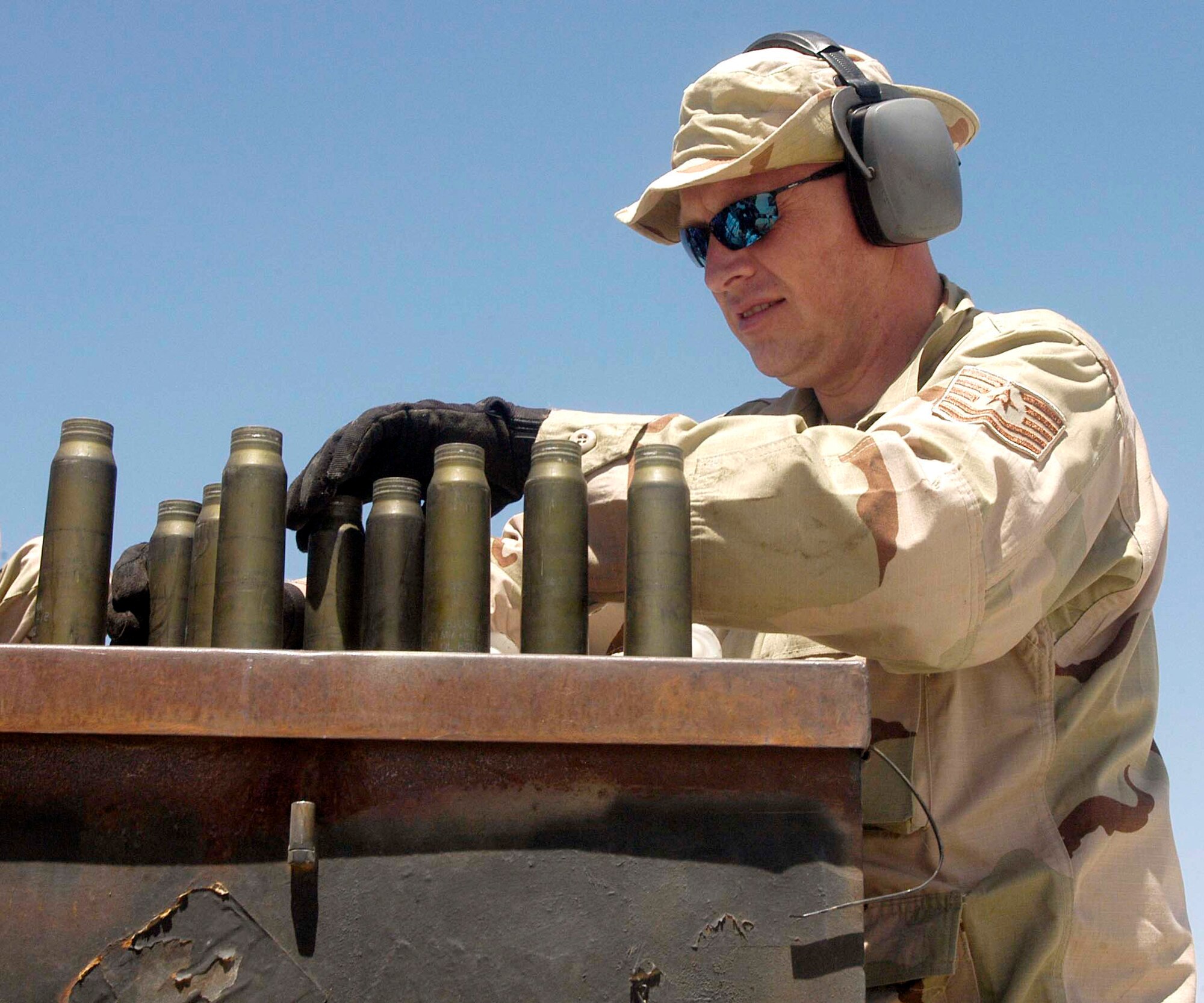 Tech. Sgt. Scott Avery sorts spent 30 mm shell casings during an ammunition loading operation for an A-10 Thunderbolt II at Bagram Air Base, Afghanistan, on Sunday, July 16. Weapons loaders use a machine, called an automatic loading assembly, to simultaneously download old ammunition and upload new ammunition for the A-10's 30 mm rotating cannon. Sergeant Avery is an Air Force Reserve weapons loader deployed from the 442nd Fighter Wing at Whiteman Air Force Base, Mo. (U.S. Air Force photo/Maj. David Kurle)