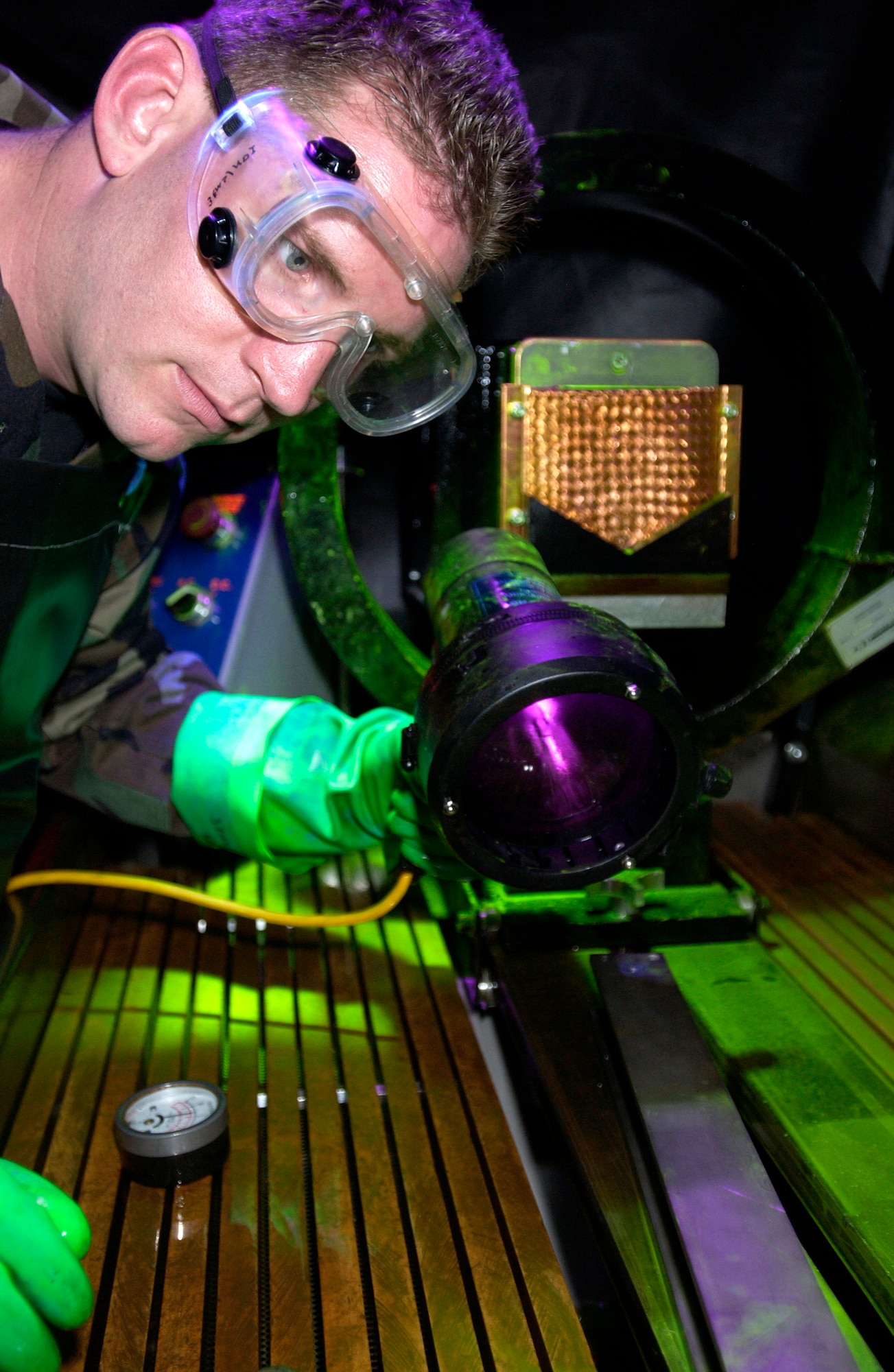 Tech. Sgt. Joseph Goff inspects an aircraft part for abnormalities before they become a problem at Elmendorf Air Force Base, Alaska. Sergeant Goff is the 3rd Equipment Maintenance Squadron Nondestructive Inspection Laboratory section chief. (U.S. Air Force photo/Tech. Sgt. Keith Brown)