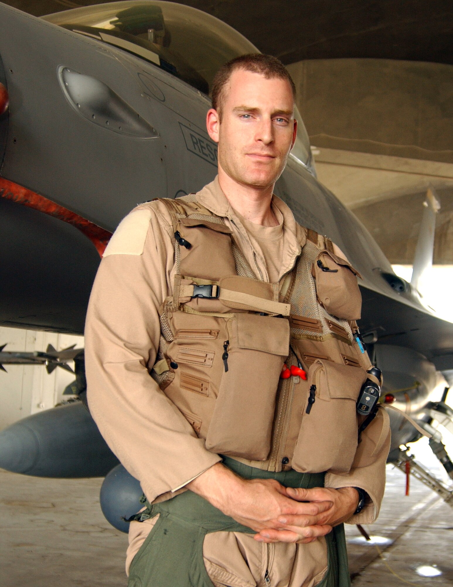 First Lt. Michael Seltzer stands with the jet that malfunctioned at the end of a mission he flew recently over Iraq. Lieutenant Seltzer is an F-16 Fighting Falcon pilot assigned to the 421st Expeditionary Fighter Squadron. (U.S. Air Force photo/Senior Airman Kerry Solan-Johnson)