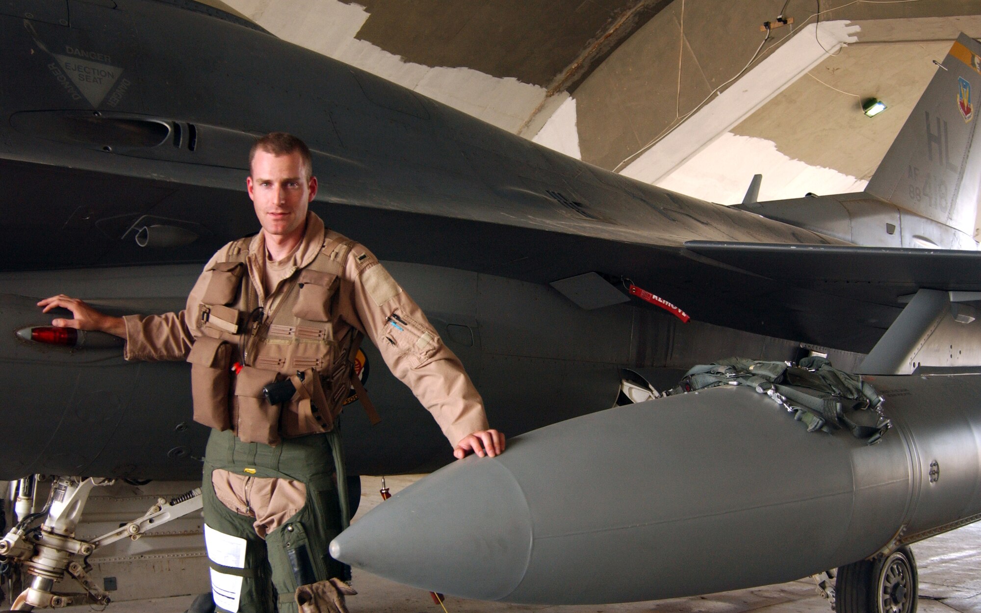 First Lt. Michael Seltzer stands with the jet that malfunctioned at the end of a mission he flew recently over Iraq. Lieutenant Seltzer is an F-16 Fighting Falcon pilot assigned to the 421st Expeditionary Fighter Squadron. (U.S. Air Force photo/Senior Airman Kerry Solan-Johnson)