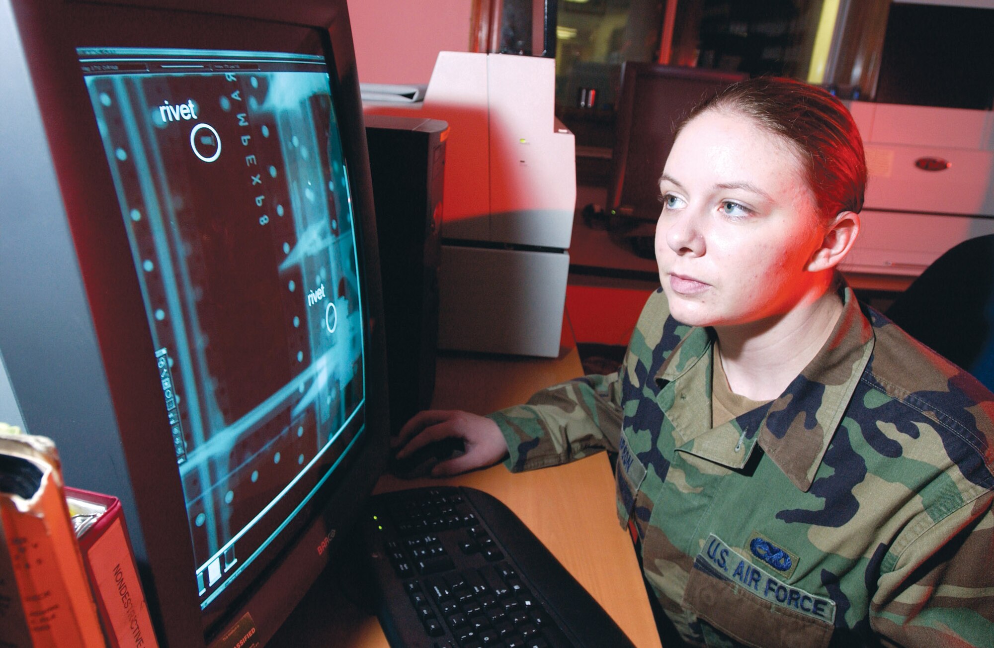 Senior Airman Jeri Thompson studies a digital X-ray from an aircraft part at Elmendorf Air Force Base, Alaska, on July 10. By switching from film to digital X-rays to analyze aircraft, the 3rd Equipment Maintenance Squadron is saving the Air Force more than $200,000 a year and no longer produces hazardous waste from processing film. Airman Thompson is a nondestructive inspection laboratory technician at the squadron. (U.S. Air Force photo/Tech. Sgt. Keith Brown)