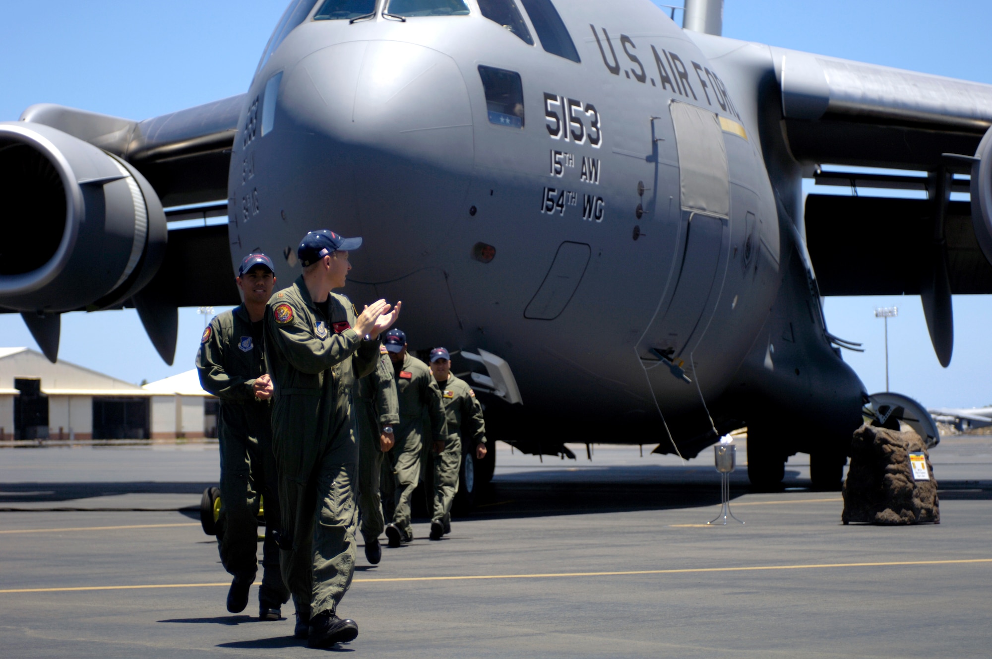 Aircrew members walk away from a C-17 Globemaster III at Hickam Air Force Base, Hawaii, on July 18. The "Spirit of Kamehameha-Imua" is the eighth and final C-17 for the 15th Airlift Wing at Hickam. It marks the successful transformation for the 15th AW from a support unit to an operational strategic airlift wing. The maintainers are active duty Airmen and Hawaii Air National Guardsmen. (U.S. Air Force photo/Tech. Sgt. Shane A. Cuomo)