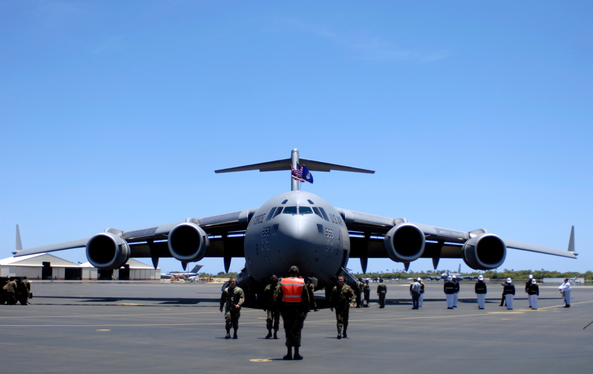 Aircraft maintainers march away from a C-17 Globemaster III after parking the aircraft at Hickam Air Force Base, Hawaii, on July 18. The "Spirit of Kamehameha-Imua" is the eighth and final C-17 for the 15th Airlift Wing at Hickam. It marks the successful transformation for the 15th AW from a support unit to an operational strategic airlift wing. The maintainers are active duty Airmen and Hawaii Air National Guardsmen. (U.S. Air Force photo/Tech. Sgt. Shane A. Cuomo)