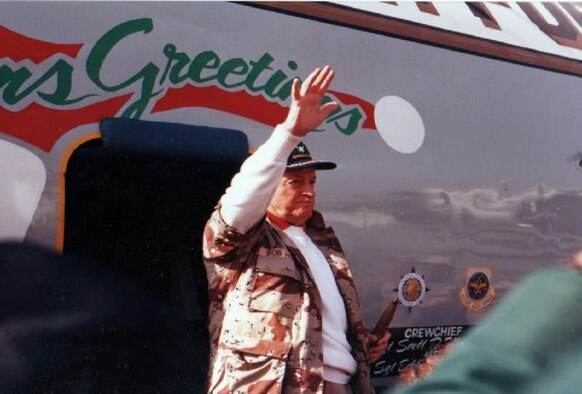 Bob Hope waves to the crowd seeing him off at an air base in Southwest Asia on Christmas Day 1990. (U.S. Air Force photo by William Scott Hubbartt-Backus)