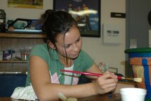 Michelle Chiaravalle, daughter of 1st Lt. Jamal Quinnert, 60th Communications Squadron Plans and Implementation deputy chief, restores a pot at the Teen Center at Travis Air Force Base, Calif. Michelle was named AMC Youth of the Year for 2006. (U.S. Air Force photo/Staff Sgt. Matthew McGovern)