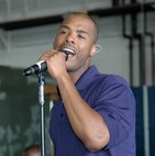 YOUNGSTOWN AIR RESERVE STATION, Ohio - TSgt. Aaron L. Miles, operations NCO and a vocalist with the Reserve Generation Band, part of The Band of the United States Air Force Reserve, based at Robins AFB, Ga., entertains a crowd of hundreds of people during Family Day festivities July 15 at Air Force Reserve Command's 910th Airlift Wing here.  U.S. Air Force photo/Master Sgt. Bryan Ripple.