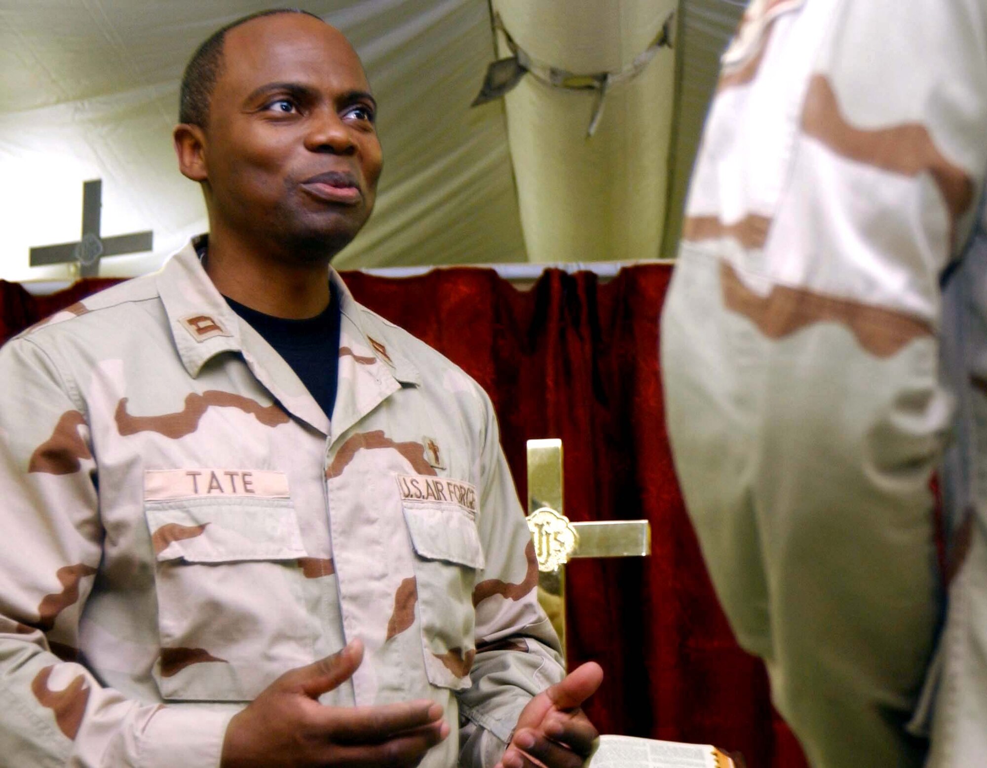 Chaplain (Capt.) Jose Tate speaks to an Airman at the Air Force Theater Hospital at Balad Air Base, Iraq, on July 14. Chaplains support the hospital's patients, staff and many off-duty Airmen who volunteer there. The chaplain is assigned to the 332nd Air Expeditionary Wing. (U.S. Air Force photo/Senior Airman Kerry Solan-Johnson)