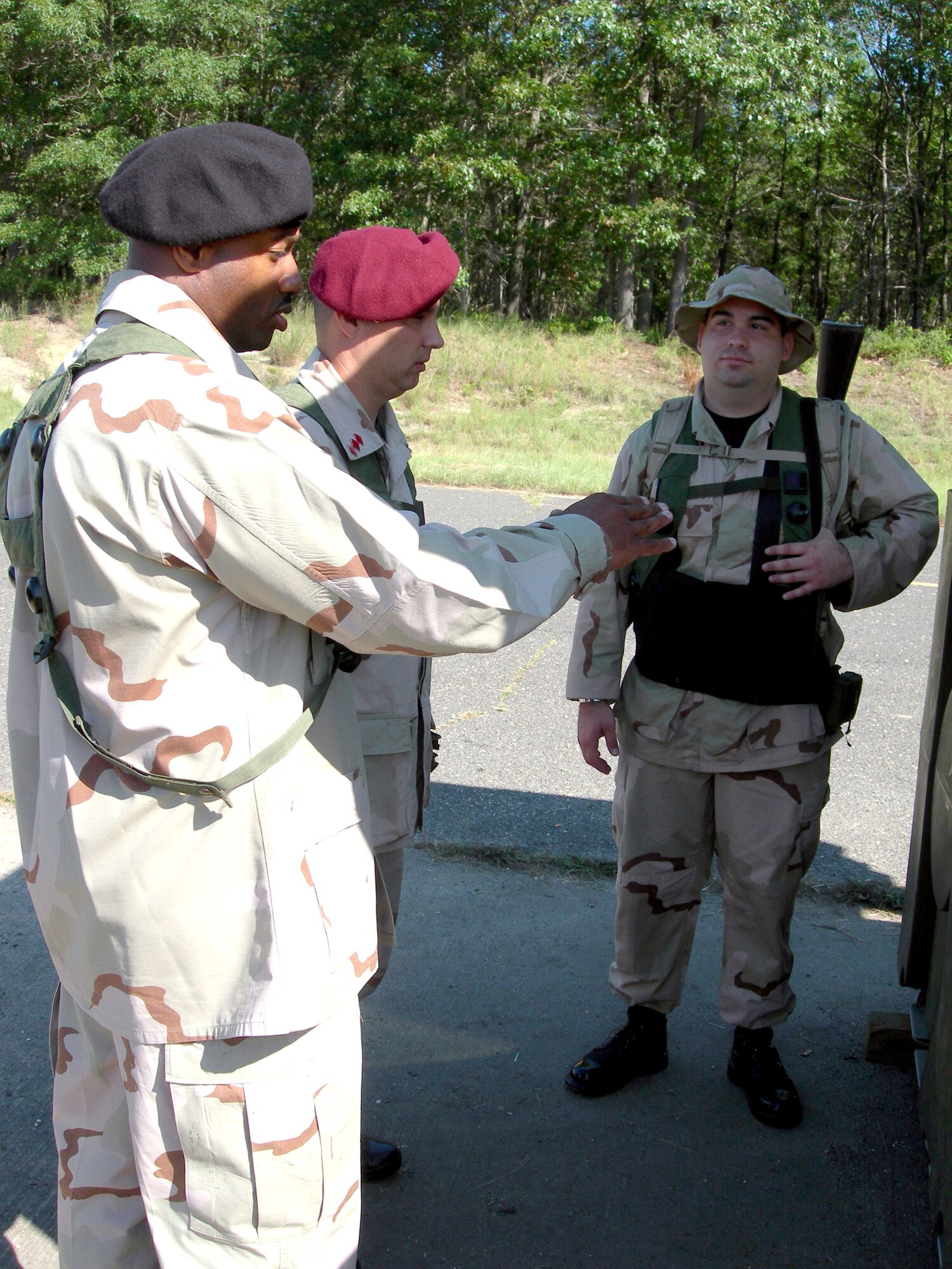 Airmen participating as role players in a foreign national army discuss strategy during a scenario as part of Exercise Eagle Flag 06-3 at Naval Air Engineering Station Lakehurst, N.J., on July 14. The exercise tests Airmen from various career fields on their expeditionary combat support skills. (U.S. Air Force photo/Tom Fuller)