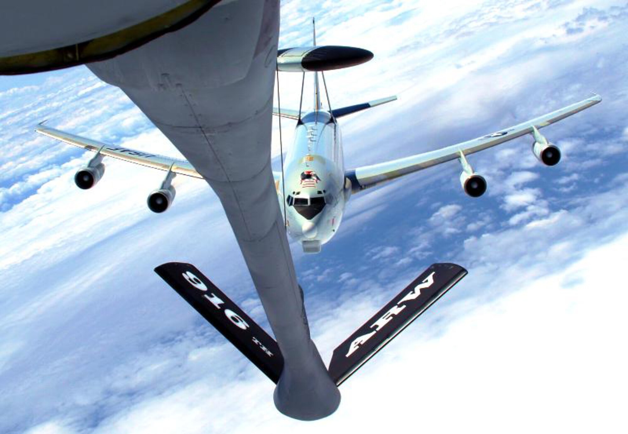 A perfect day for taking a picture while flying is when the sky is blue and there are plenty of clouds. The E-3 AWACS is just another bonus in the sky.