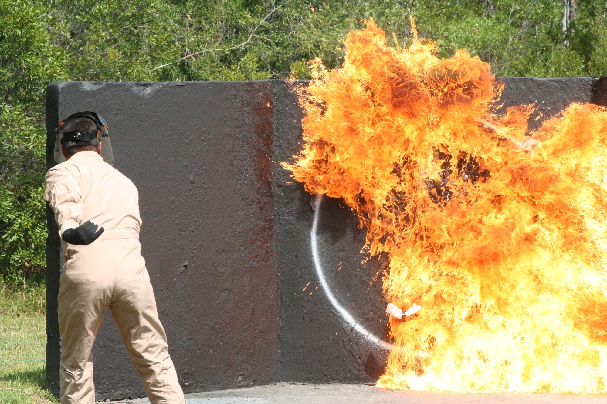 An instructor from the Dynamics International of Terrorism course demonstrates the destructive capabilities of a Molotov cocktail at Hurlburt Field July 12. (U.S. Air Force Photograph by Staff Sgt. Mareshah Haynes)