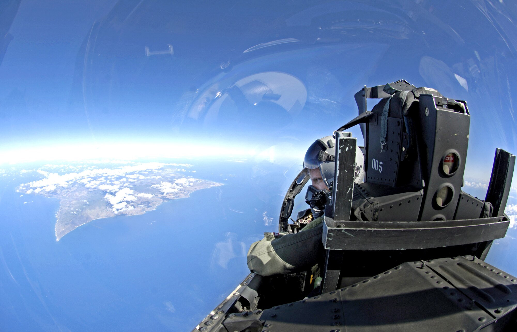 Capt. Michael Blake looks out of his F-15 Eagle on approach to the island of Oahu, Hawaii, on July 16. He was flying a mission in support of the Rim of the Pacific Exercise 2006. The captain is a pilot with the Hawaii Air National Guard's 199th Fighter Squadron. (U.S. Air Force photo/Tech. Sgt. Shane A. Cuomo)