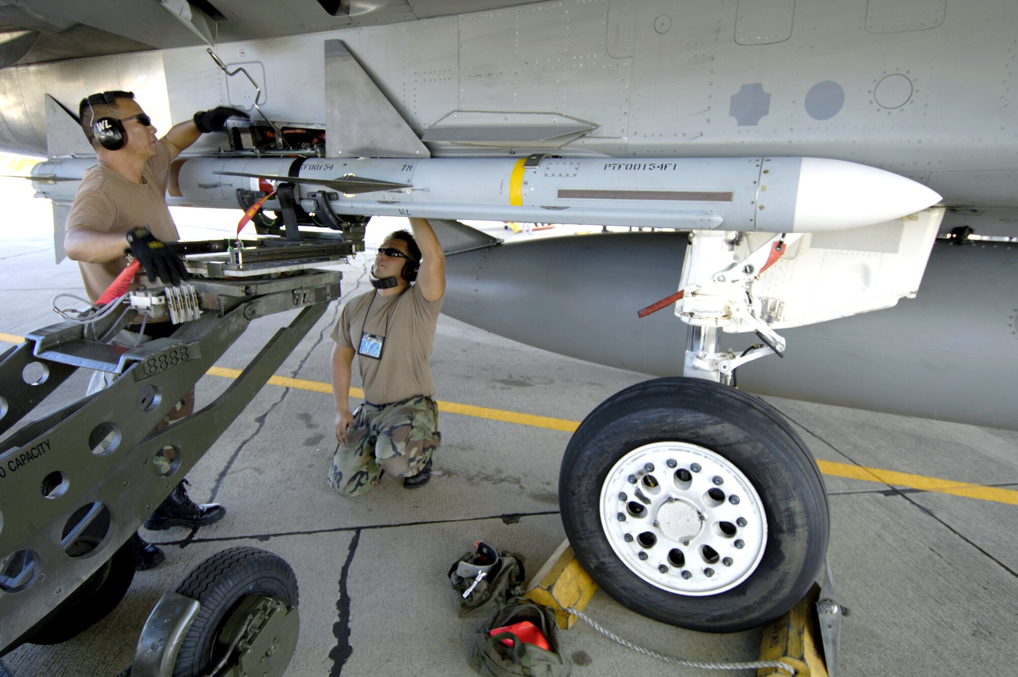 Staff Sgt. Arthur Hamabata and Staff Sgt. Gabriel Coronado load an AIM-7 Sparrow missile on an F-15 Eagle at Hickam Air Force Base, Hawaii, on July 16 during the Rim of the Pacific Exercise 2006. The Airmen are from the Hawaii Air National Guard's 154th Aircraft Maintenance Squadron. (U.S. Air Force photo/Tech. Sgt. Shane A. Cuomo) 