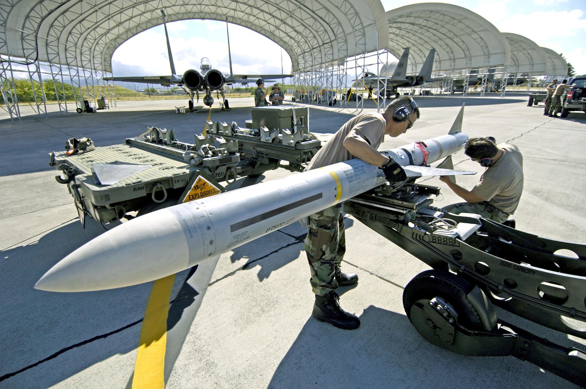 Staff Sgt. Arthur Hamabata and Staff Sgt. Gabriel Coronado install the wings and fins on an AIM-7 Sparrow missile at Hickam Air Force Base, Hawaii, on July 16 during the Rim of the Pacific Exercise 2006. The Airmen are with the Hawaii Air National Guard's 154th Aircraft Maintenance Squadron. (U.S. Air Force photo/Tech. Sgt. Shane A. Cuomo) 