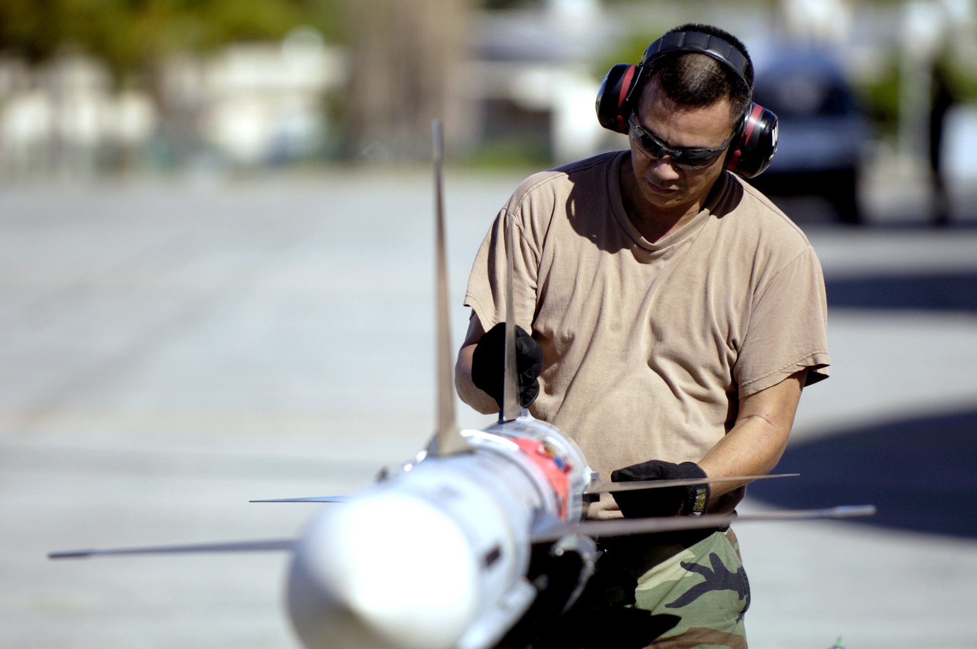 Staff Sgt. Arthur Hamabata installs fins on an AIM-7 Sparrow missile at Hickam Air Force Base, Hawaii, on July 16 during the Rim of the Pacific Exercise 2006. Sergeant Hamabata is with the Hawaii Air National Guard's 154th Aircraft Maintenance Squadron. (U.S. Air Force photo/Tech. Sgt. Shane A. Cuomo)