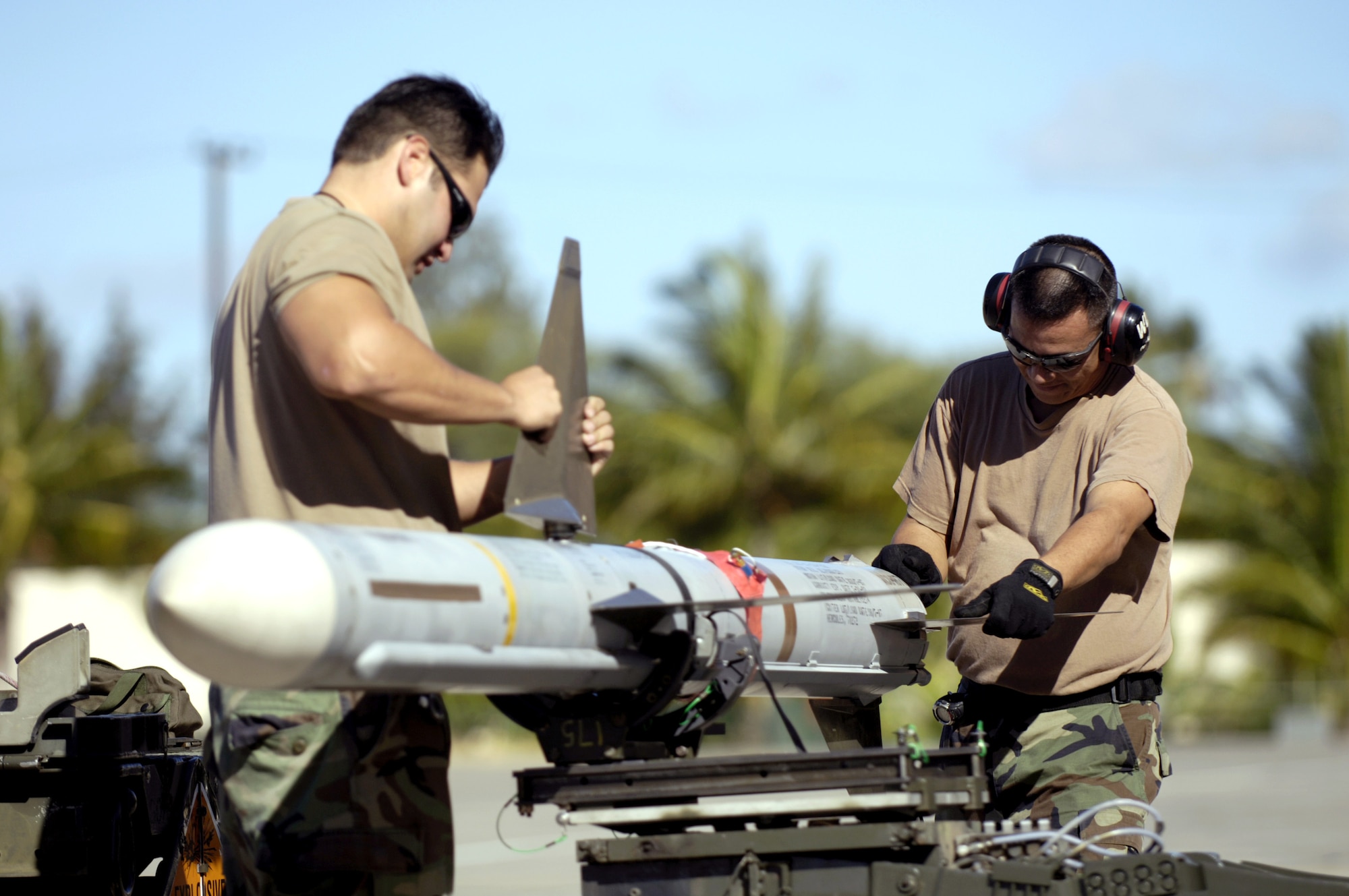 Staff Sgt. Gabriel Coronado and Staff Sgt. Arthur Hamabata install the wings and fins on an AIM-7 Sparrow missile at Hickam Air Force Base, Hawaii, on July 16 during the Rim of the Pacific Exercise 2006. The Airmen are from the Hawaii Air National Guard's 154th Aircraft Maintenance Squadron. (U.S. Air Force photo/Tech. Sgt. Shane A. Cuomo) 