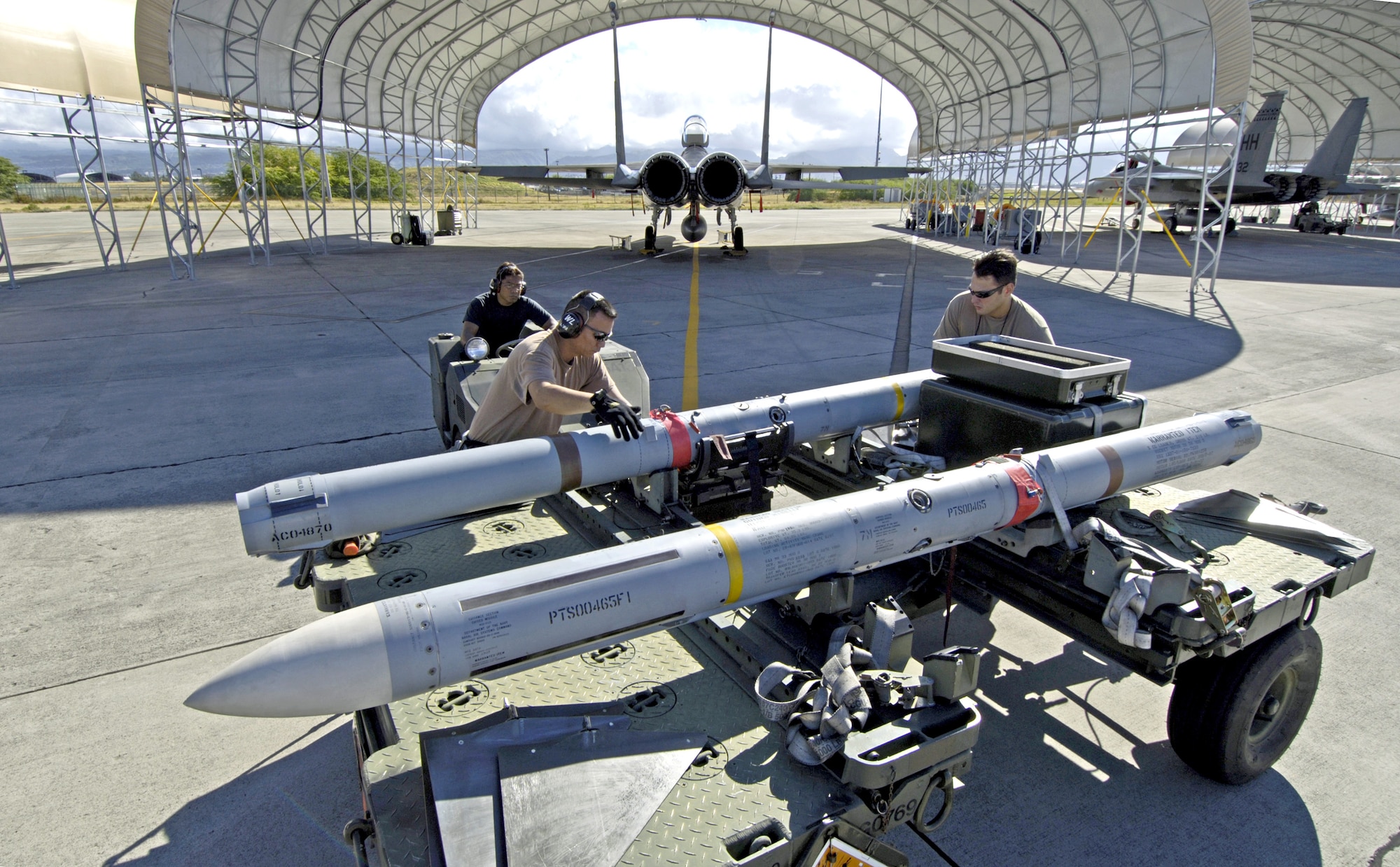 Weapons loaders prepare to load an AIM-7 Sparrow missile on an F-15 Eagle at Hickam Air Force Base, Hawaii, on July 16 during the Rim of the Pacific Exercise 2006. The Airmen are with the Hawaii Air National Guard's 154th Aircraft Maintenance Squadron. (U.S. Air Force photo/Tech. Sgt. Shane A. Cuomo)