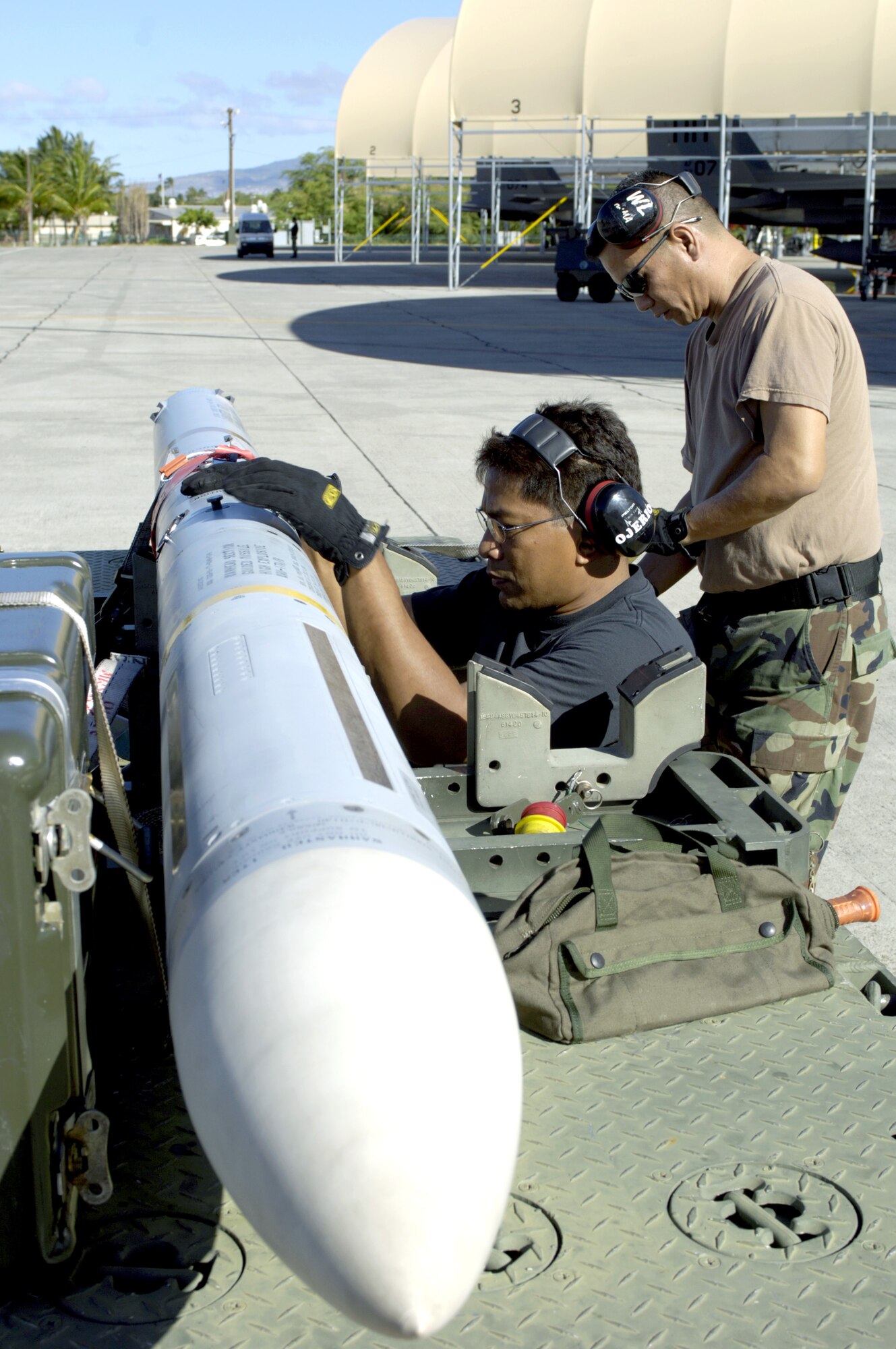 Master Sgt. Baldwin Ojerio and Staff Sgt. Arthur Hamabata inspect an AIM-7 Sparrow missile before loading it on an F-15 Eagle at Hickam Air Force Base, Hawaii, on July 16 during the Rim of the Pacific Exercise 2006. The Airmen are from the Hawaii Air National Guard's 154th Aircraft Maintenance Squadron. (U.S. Air Force photo/Tech. Sgt. Shane A. Cuomo) 